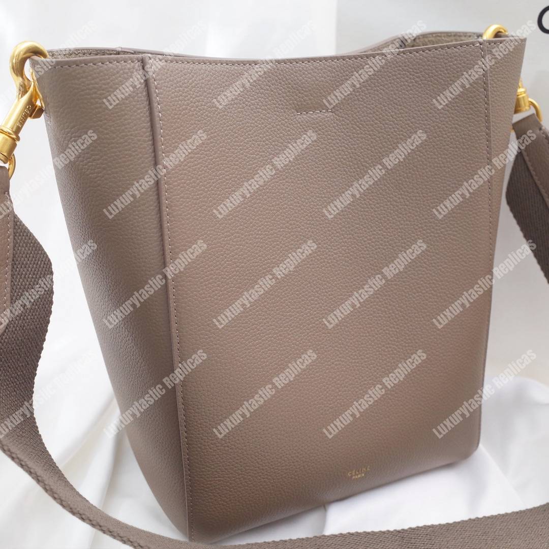 Ce**e sangle small bucket bag in soft grained calfskin taupe