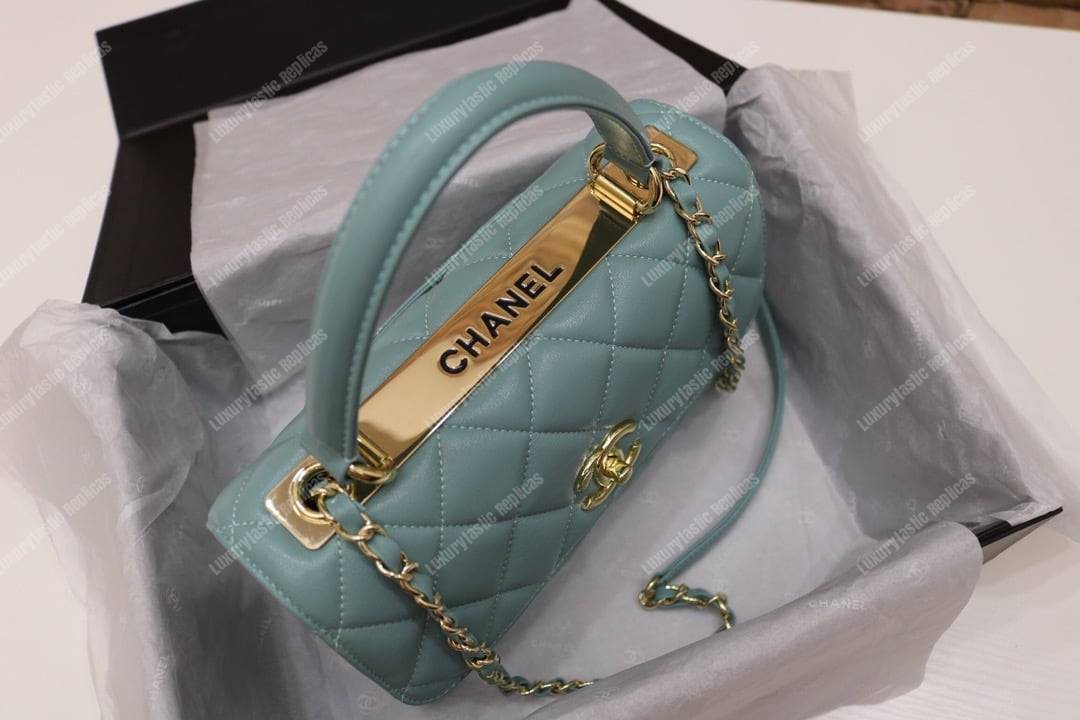 Ch*el small flap bag with top handle light blue-gold