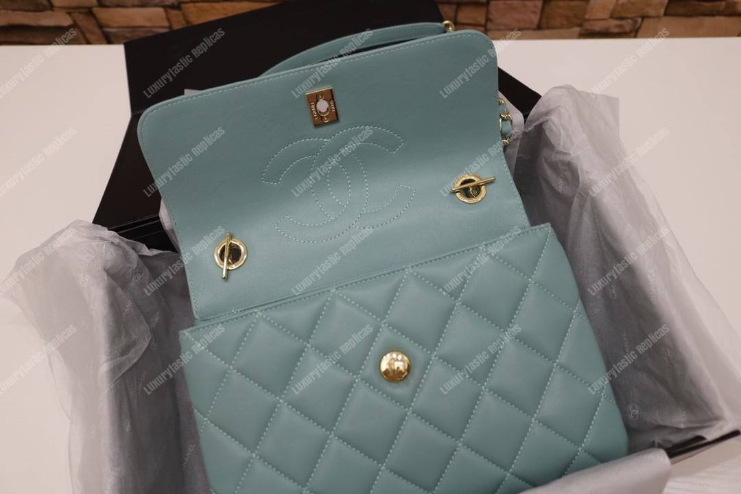 Ch*el small flap bag with top handle light blue-gold