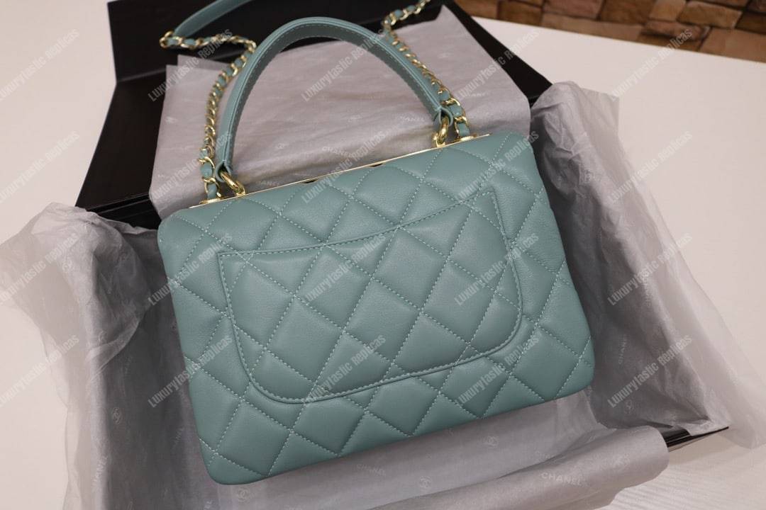 Ch*el small flap bag with top handle light blue-gold