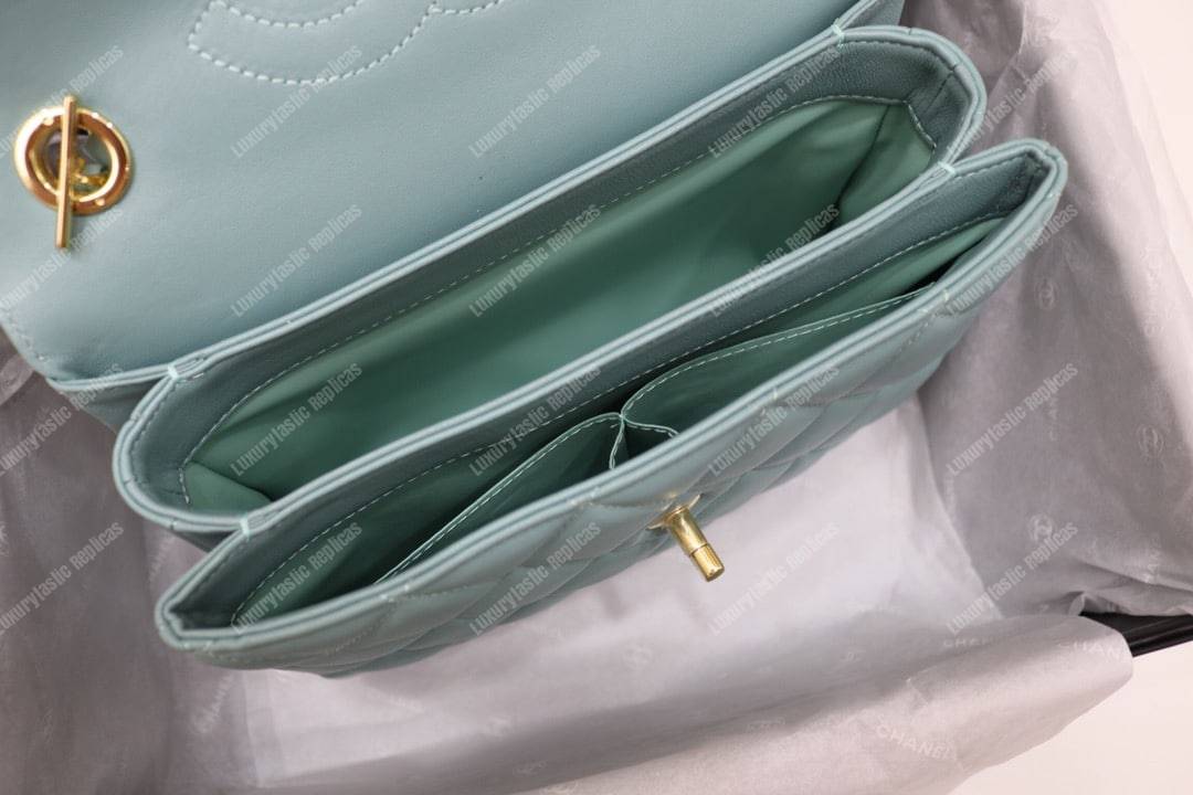 Ch*el small flap bag with top handle light blue-gold