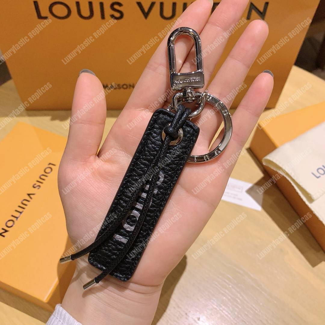 lv tab l**is V*t*n bag charm and key holder