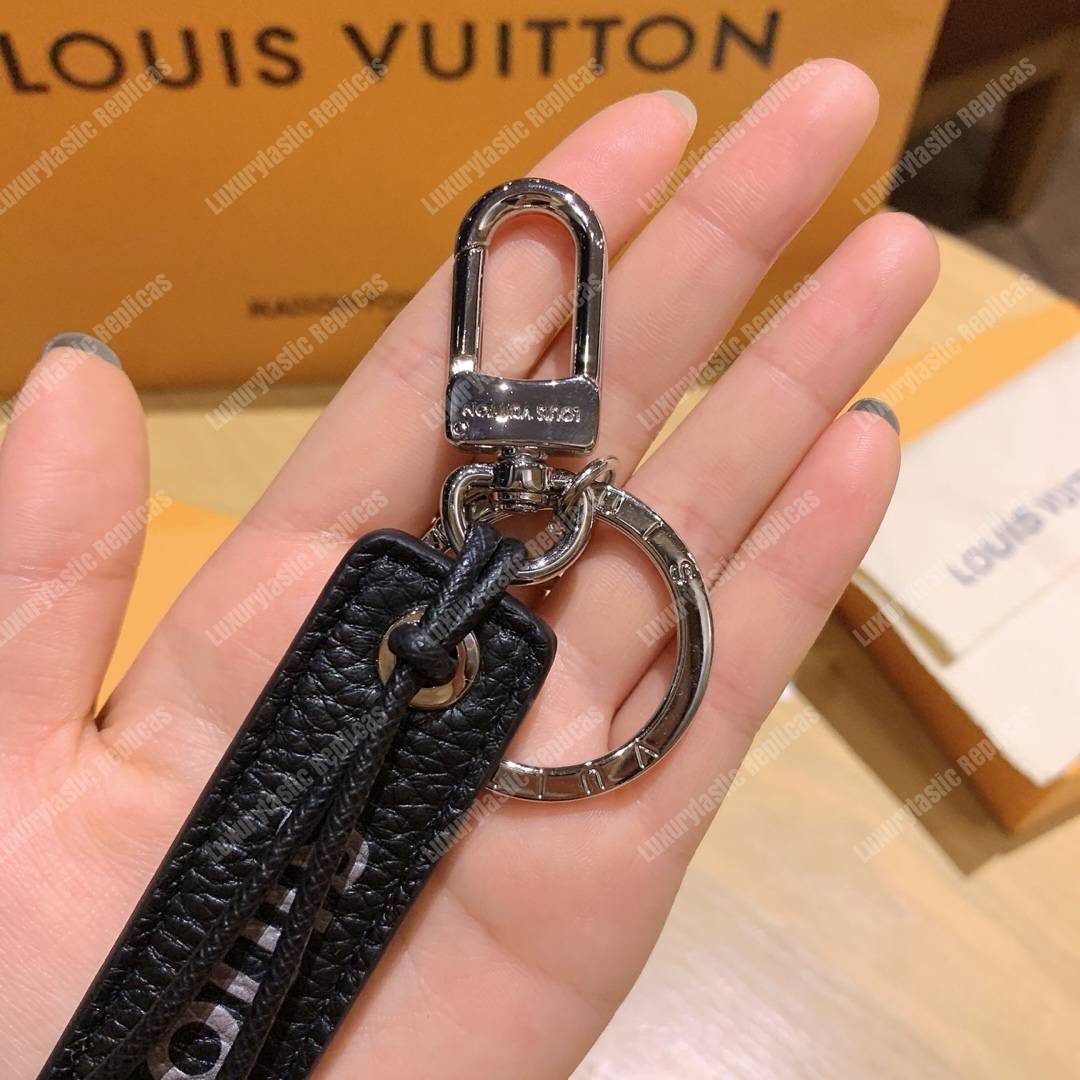 lv tab l**is V*t*n bag charm and key holder