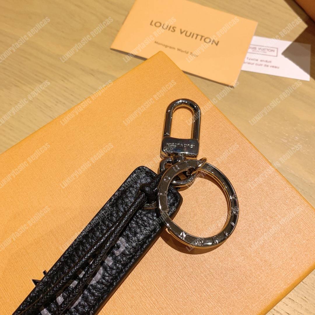lv tab l**is V*t*n bag charm and key holder