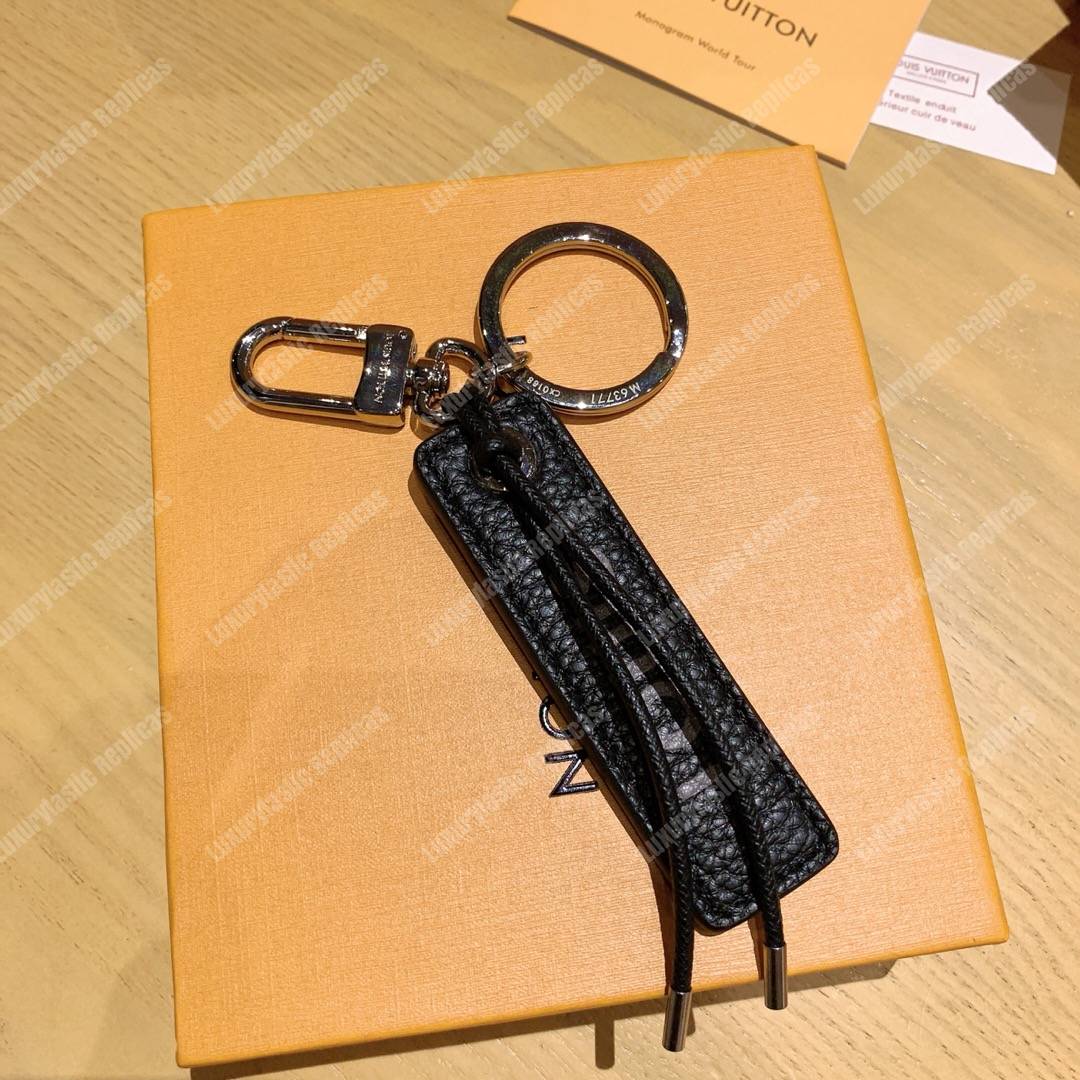 lv tab l**is V*t*n bag charm and key holder