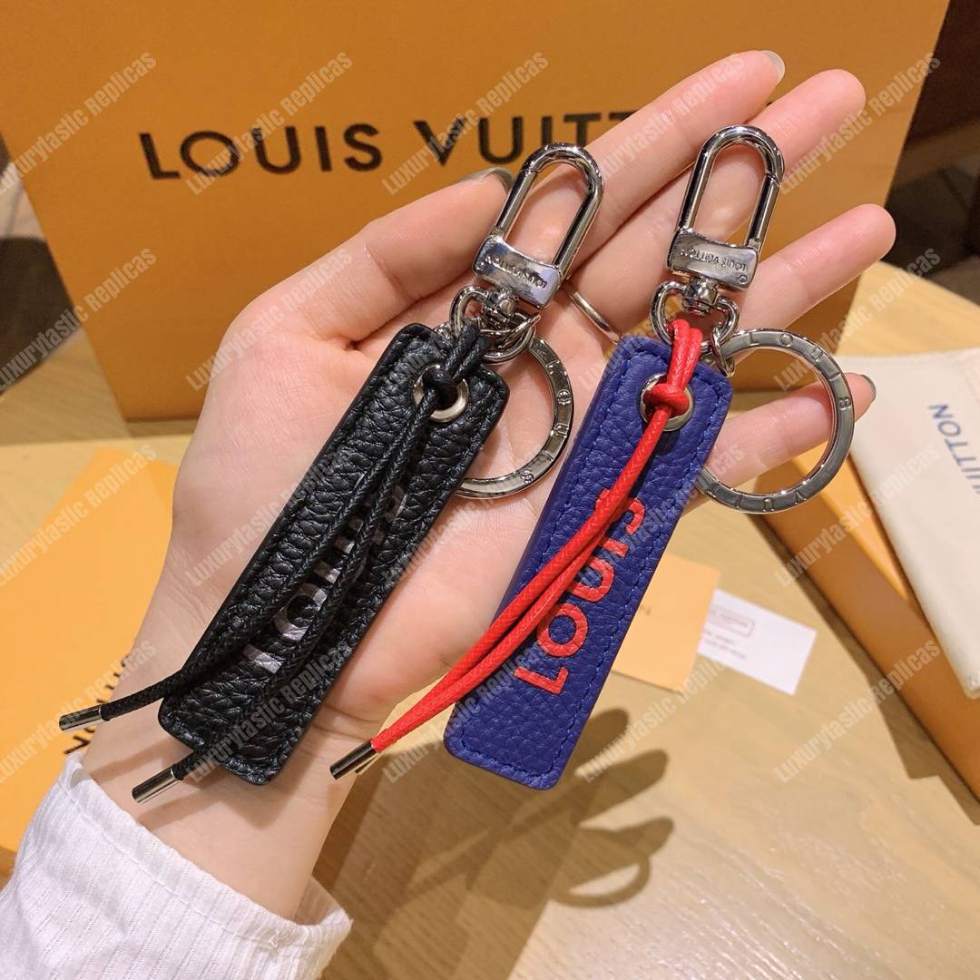 lv tab l**is V*t*n bag charm and key holder